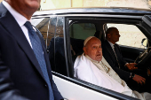 Pope Francis looks on as he leaves Regina Coeli prison after a visit, in Rome