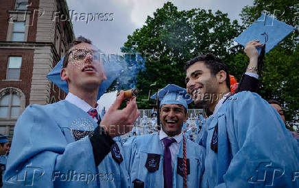 Graduating students celebrate during Columbia University's commencement ceremony on its main campus, in Manhattan, New York City