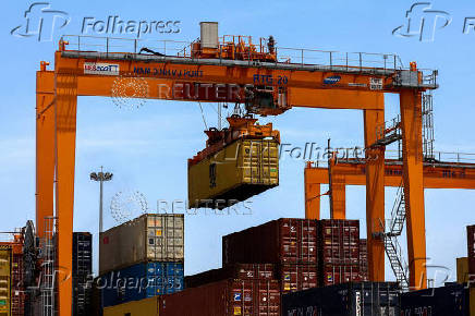 FILE PHOTO: FILE PHOTO: A container is loaded onto a cargo ship while docked at Hai Phong port in Vietnam