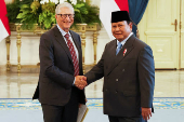 Bill Gates shakes hands with Indonesian President Prabowo Subianto before their meeting at the Merdeka Palace in Jakarta