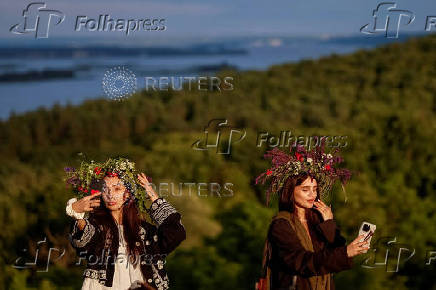 People take part in a celebration on the traditional Ivana Kupala in the village of Vytachiv, in Kyiv region