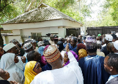 Mourners wait to gain access into former president Buhari's residence ahead of his burial