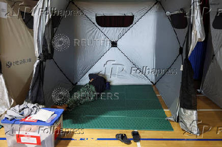 People evacuated from villages, damaged by torrential rain, rest at a temporary shelter, in Yesan,