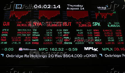 A screen displays indexes after the closing bell at the NYSE in New York