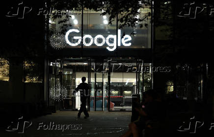 Pedestrian walks past the Google offices in London