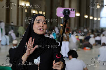 Journalist uses mobile phone to film at the Grand Mosque in the holy city of Mecca