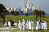 Israeli Muslims pray on the first day of the Muslim holiday of Eid al-Adha by the sea side of the Mediterranean, in Jaffa