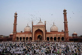 Muslims offer prayers at the Jama Masjid on the occasion of Eid al-Adha, in the old quarters of Delhi