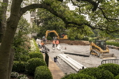 Workers reconstruct the Rose Garden to pavement at the White House
