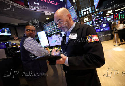 Traders work on the floor at the New York Stock Exchange, in New York City