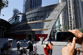 People take photos of the new Louis Vuitton store in Shanghai