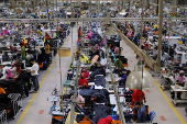 Bangladeshi garment workers sew at a textile factory in Gazipur