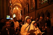 Worshippers participate in Stations of the Cross at St Mary’s Catholic Cathedral in Sydney