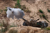 A mobile artillery unit fires towards Gaza, as seen from the Israel
