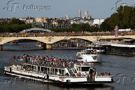 A tourist boat travels on the River Seine in Paris