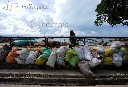 FILE PHOTO: Plastic waste collected from fishing nets, filled into bags, is placed near a beach in Galle