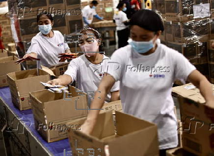 President Ferdinand Marcos visits a relief goods warehouse in Manila as Tropical Storm 'Crising apporaches