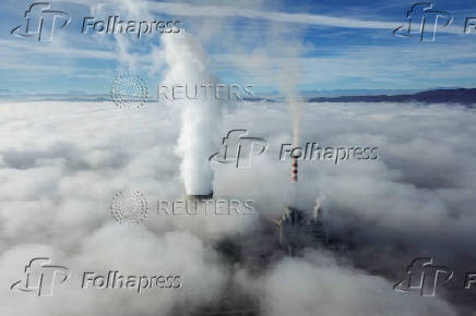 A drone view shows smoke rising from the coal-fired power plant, in Obilic