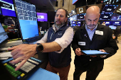 Traders work on the floor at the New York Stock Exchange, in New York City