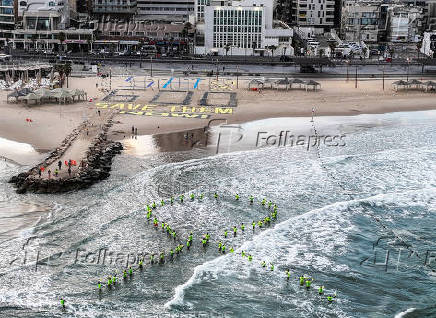 A drone view shows Israeli protesters display the words 
