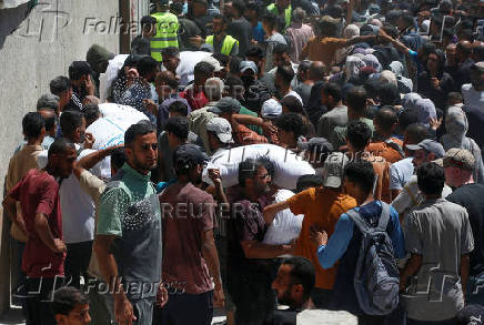Palestinians gather to receive aid at a distribution center, in Gaza City
