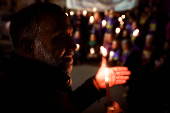 A man holds a candle during a protest against Argentine President Javier Milei?s education budget, in Buenos Aires