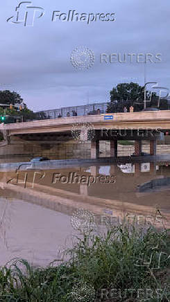 Vehicles stand on a flooded road, in Chattanooga