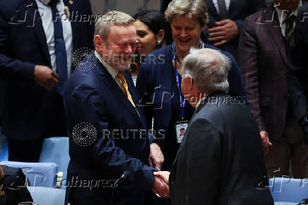 Britain?s Lord Collins of Highbury greets United Nations Secretary General Antonio Guterres ahead of U.N. Security Council meeting on Israel and Palestinian conflict