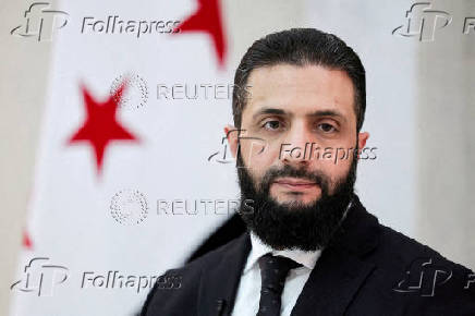 FILE PHOTO: Syria?s interim President Ahmed al-Sharaa attends an interview with Reuters