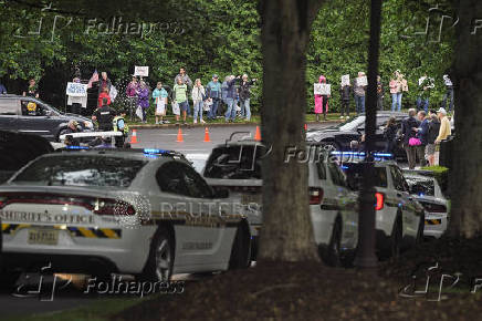 Demonstrators gather outside Trump National Golf Course ahead of President Trump?s meme coin gala in Sterling