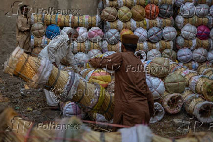 Men arrange cane stools for sale in Rawalpindi, Pakistan