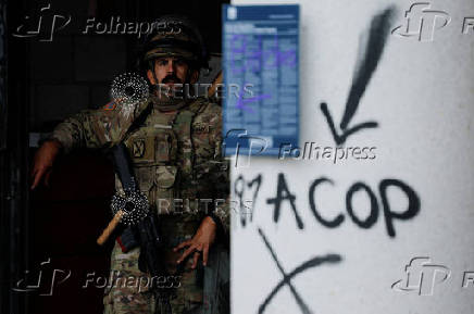 California National Guard troops stand outside the Edward R. Roybal federal building, in Los Angeles