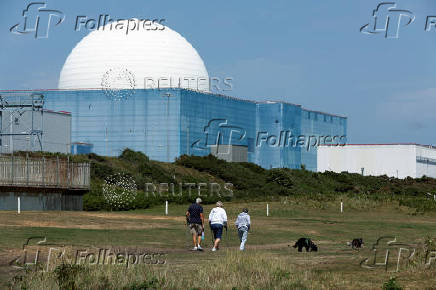 People walk near Sizewell B nuclear power plant in Suffolk England