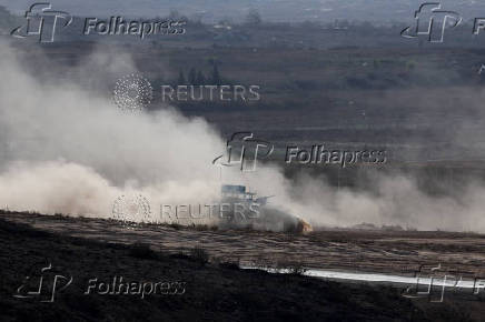 An armoured personnel carrier (APC) manoeuvres on the Israeli side of the Israel-Gaza border