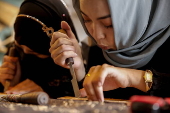Afghan girl teach Nuristani wood carving skills at a workshop in Kabul