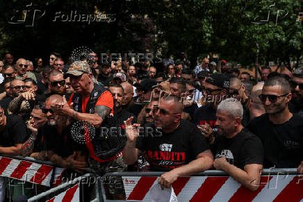 AC Milan 'ultra' soccer fans wait outside a high-security courtroom in Milan, Italy