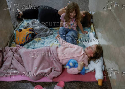 People take shelter inside a metro station during an air raid alert in Kyiv