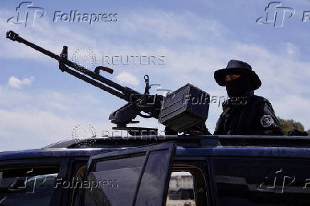 FILE PHOTO: Syrian security forces deployed in the village of Al-Soura al-Kubra