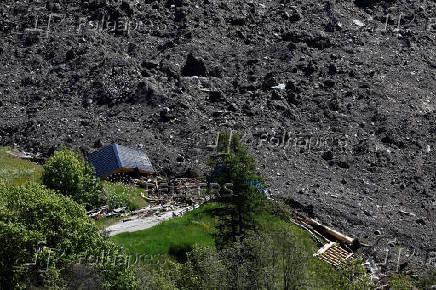 Debris and dust from a crumbling glacier that partially collapsed and tumbled onto the village of Blatten