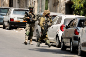 Israeli soldiers take part in an Israeli raid in Nablus