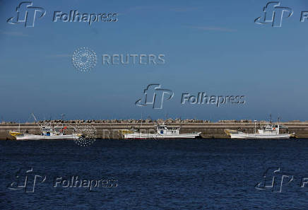 Fishing boats are anchored at a fishing port in Soma