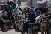 Displaced Palestinians flee their homes in the town of Beit Lahia, north of Gaza City,