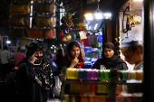 Women shop at a market ahead of the Eid al-Adha festival in the old quarters of Delhi