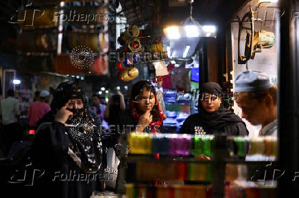 Women shop at a market ahead of the Eid al-Adha festival in the old quarters of Delhi