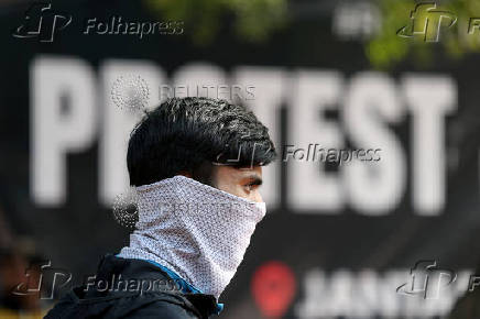 A demonstrator wearing a mask participates in a protest demanding government to take immediate steps to control air pollution in New Delhi