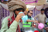 Volunteers distribute cold drinks on a roadside in Hyderabad