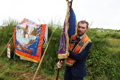 People participate in the Orange Order march along the beach in Rossnowlagh
