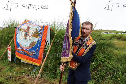 People participate in the Orange Order march along the beach in Rossnowlagh