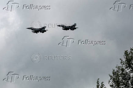 FILE PHOTO: Ukrainian F-16 fighting aircrafts are seen in the air during marking the Day of the Ukrainian Air Forces in an undisclosed location in Ukraine