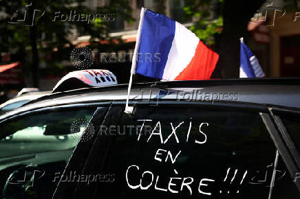 French taxi drivers protest near the Bercy Economy and Finance Ministry in Paris